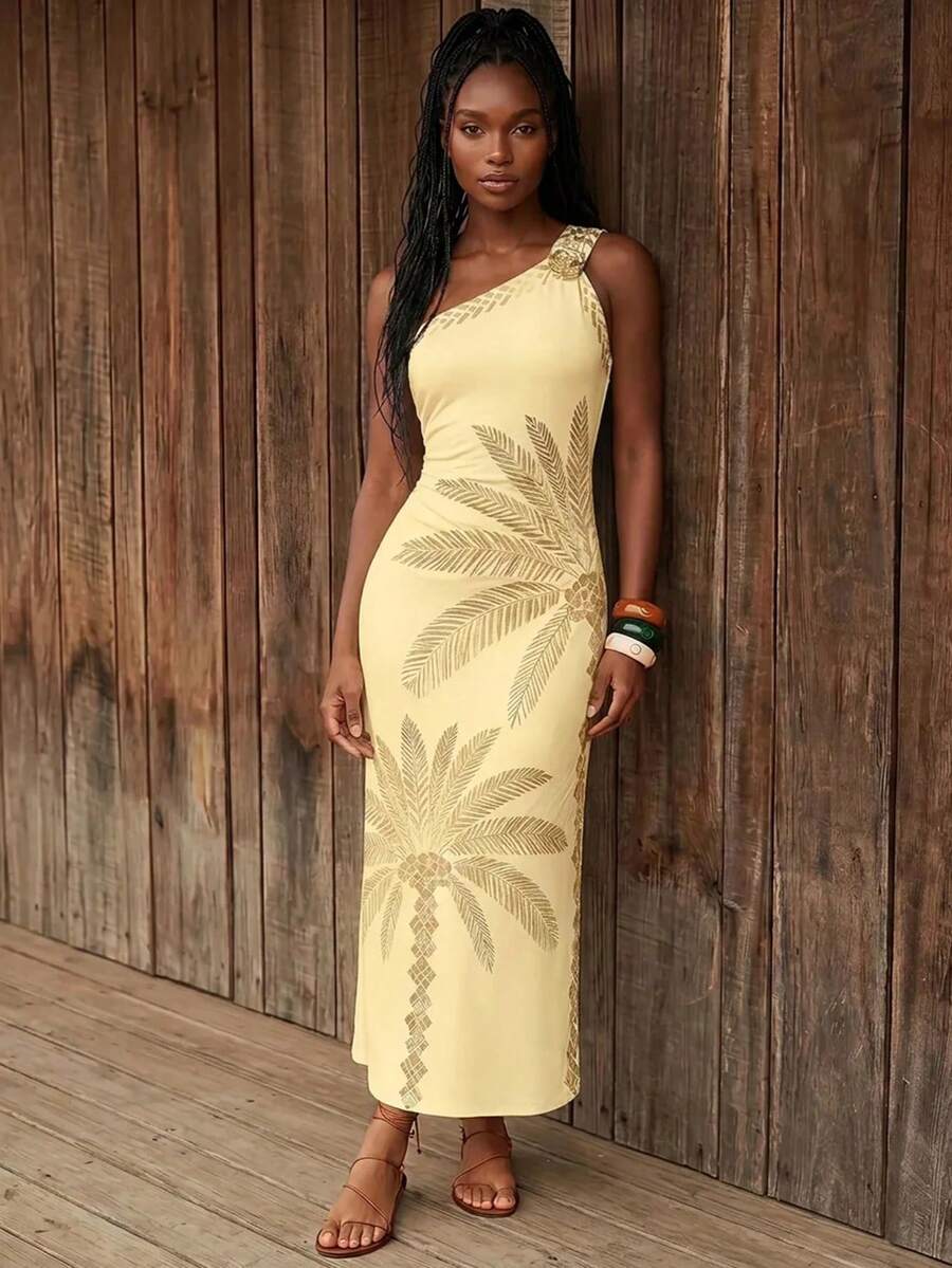 Front view of pale yellow botanical print one-shoulder maxi dress with floral brooch