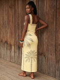 Back view of pale yellow botanical print one-shoulder maxi dress with open back