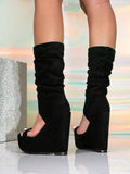 Front-rear view of black ruched mid-calf wedge boots with ultra-high platform wedges