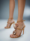 Side-front worn view of khaki scallop-shell T-strap square-toe stiletto sandals with ankle buckle for beach party styling