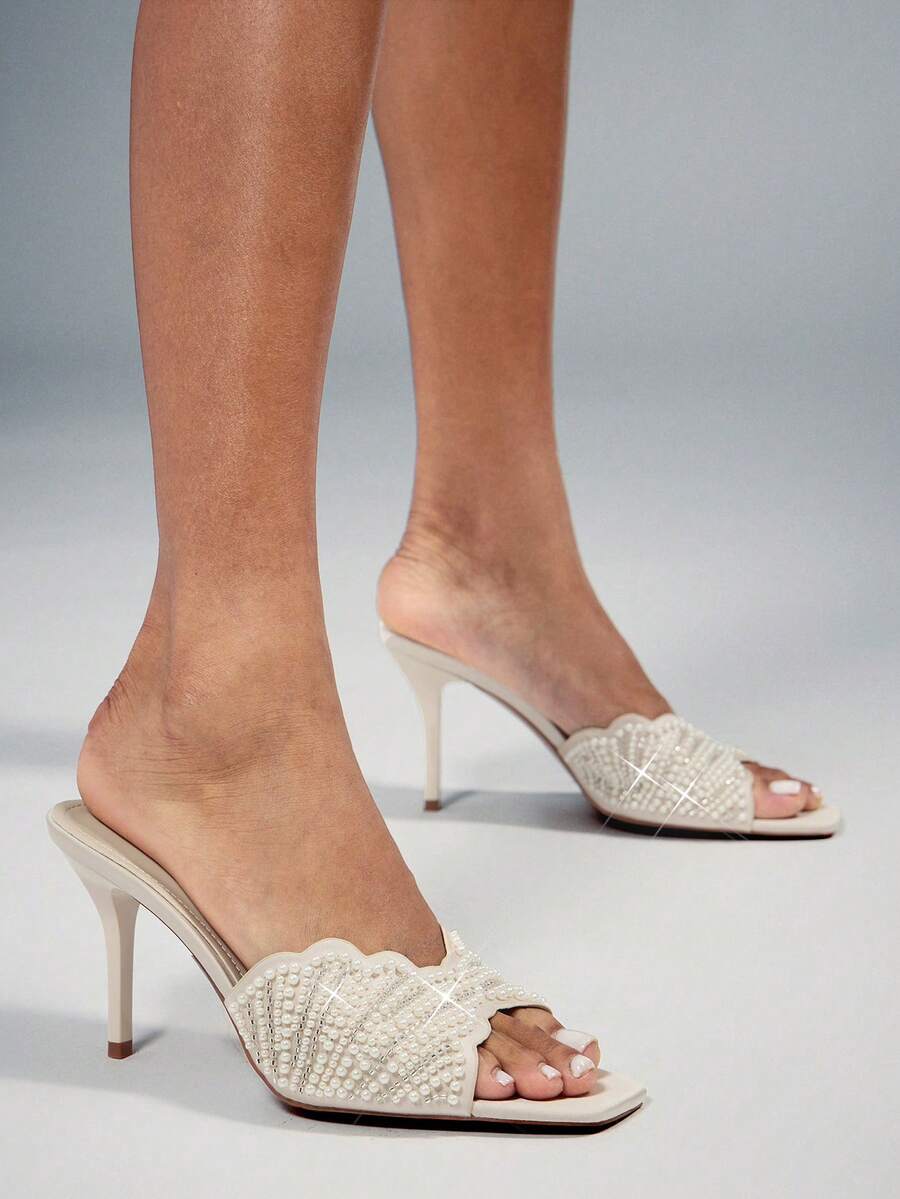 Make a sophisticated statement with these glamorous square toe stiletto sandals for women. Designed with a sleek slip on silhouette, elegant square toe, and slender stiletto heel, these sandals create a refined and feminine look that instantly elevates dressy outfits.