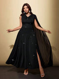 Front view of black plus size cowl neck maxi dress with asymmetric shoulder drape and slit