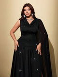 Close front view of black cowl neck plus size dress with ruched waist and thigh slit