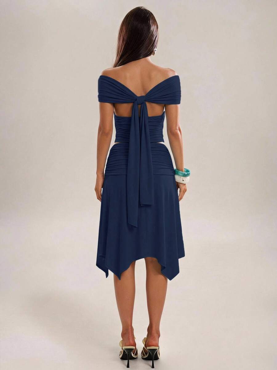 Navy blue two-piece outfit with draped sleeves and handkerchief hem midi skirt
