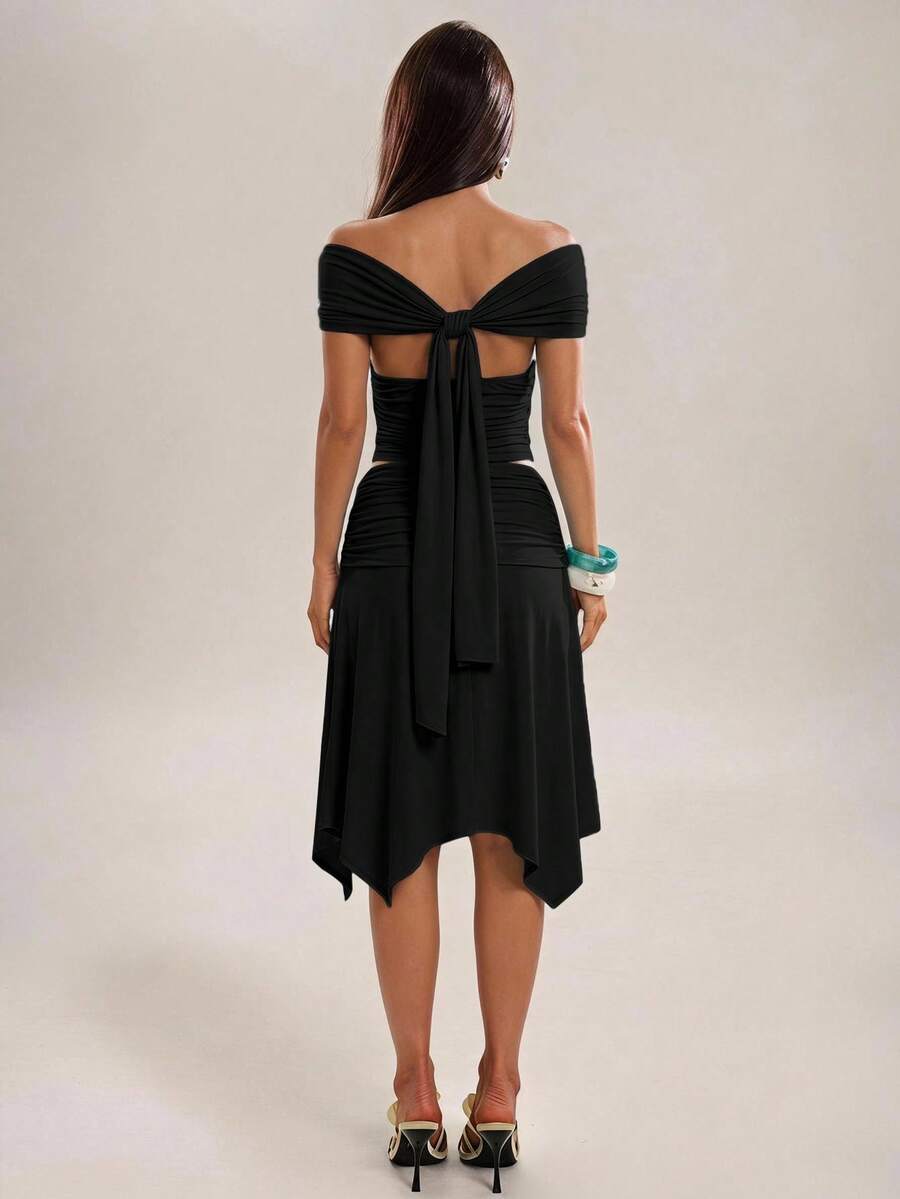 Navy blue two-piece skirt set showing draped sleeves and trailing back sash