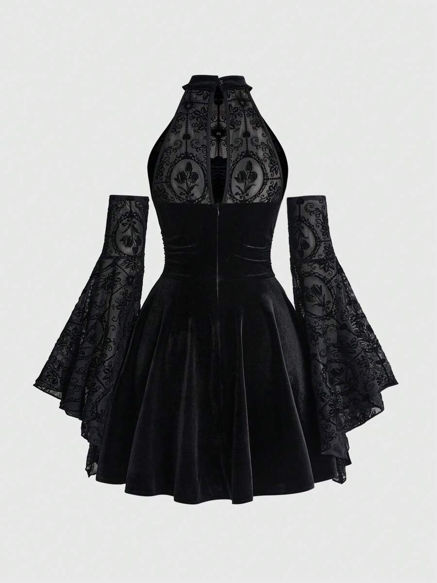 Back view of black gothic halter dress with mesh upper panel, zipper, and flared skirt