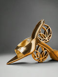 Gold pointed open toe mule heels with wide metallic vamp in studio