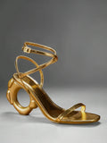 Gold square open toe ankle strap sandals with circular sculptural heel