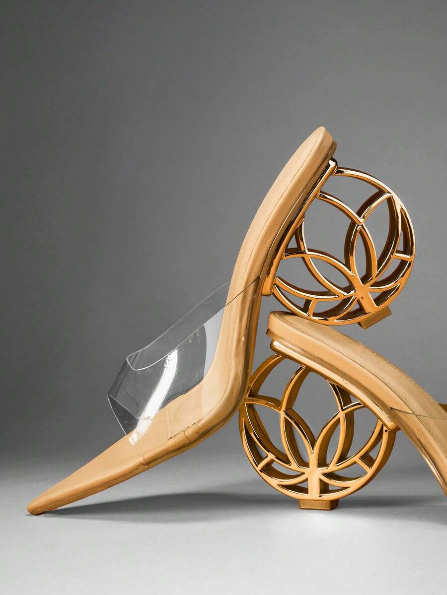Nude pointed toe mule heels with clear vamp and patterned gold wheel heel