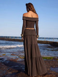 Front full view of brown twisted off-shoulder long-sleeve top and thigh-slit maxi skirt set