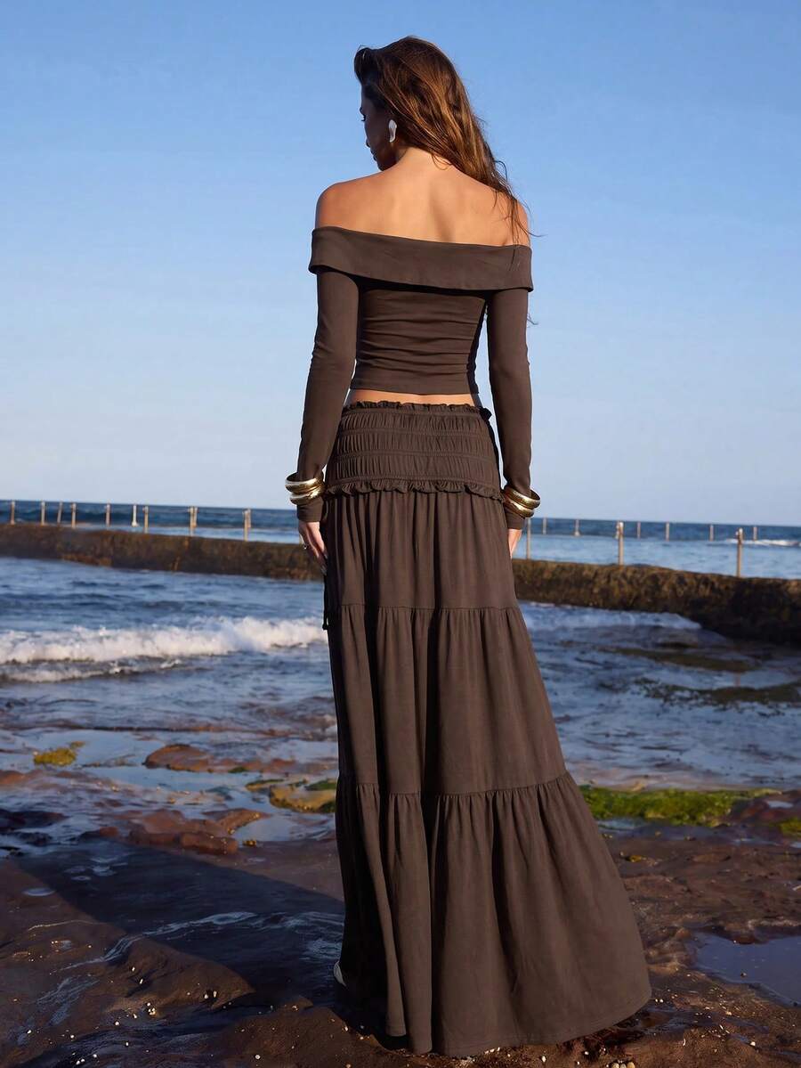 Front full view of brown twisted off-shoulder long-sleeve top and thigh-slit maxi skirt set