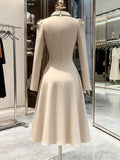 Back View of ivory blazer-style midi dress with black piping for formal work styling
