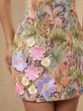Close-up of 3D pink and lavender flower appliques on floral jacquard dress