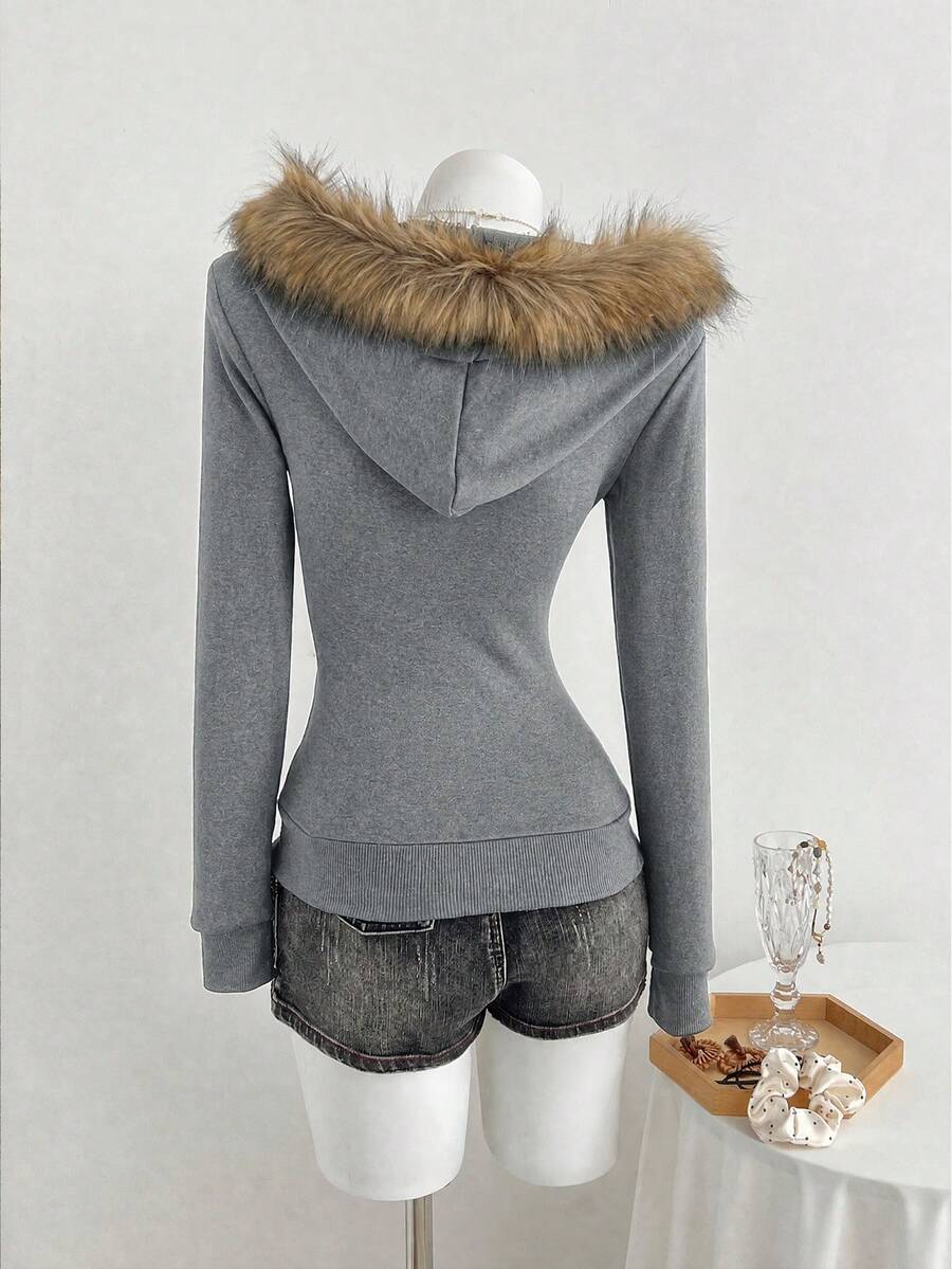 Back view of grey fitted hoodie with brown faux-fur trimmed hood