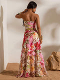 Back view of tropical multicolor print ruched bandeau top and high-slit mesh maxi skirt two-piece set for beach vacation styling