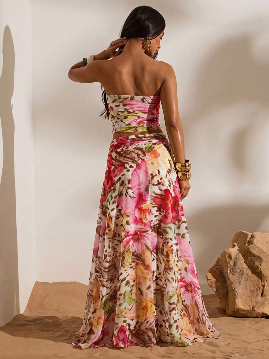 Back view of multicolor tropical print mesh bandeau crop top and flowing high-slit maxi skirt two-piece set for beach vacation styling