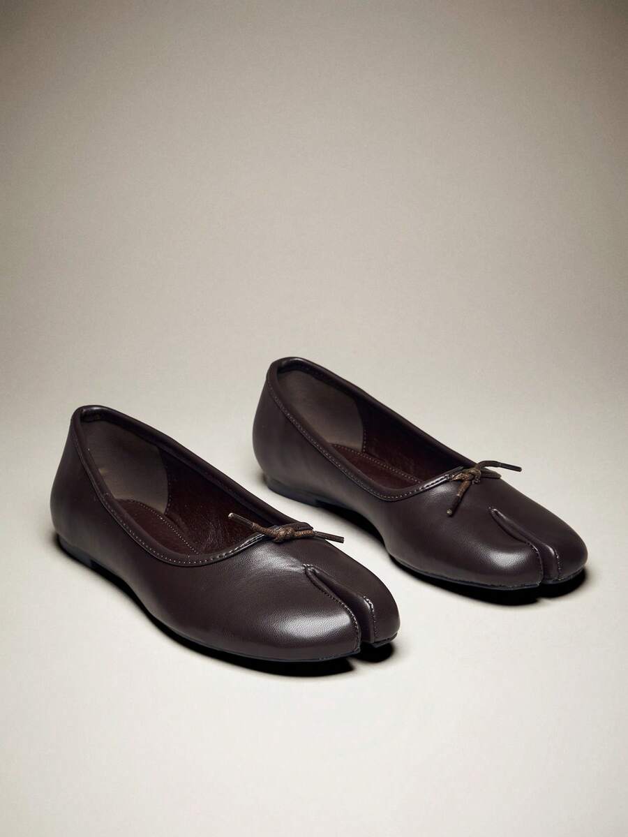 Pair of coffee brown split-toe ballet flats with bows
