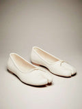 Pair of cream split-toe ballet flats