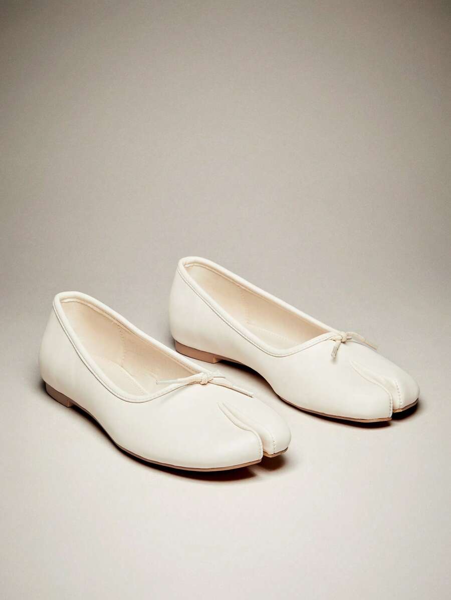 Pair of cream split-toe ballet flats