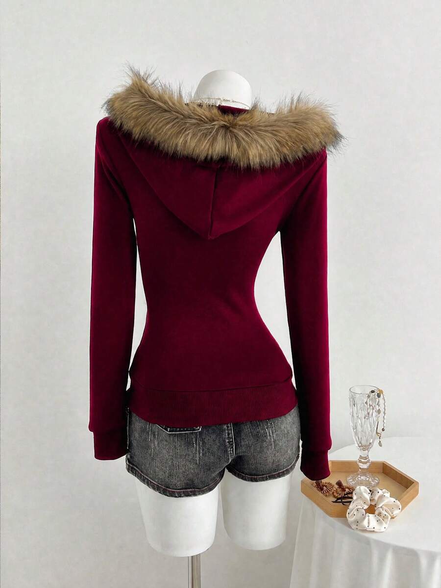 Back view of burgundy velour fitted hoodie with tan faux-fur hood trim
