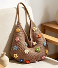 Coffee brown floral crochet shoulder bag displayed on a chair