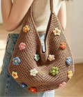 Close shoulder view of coffee brown crochet flower tote bag with openwork texture