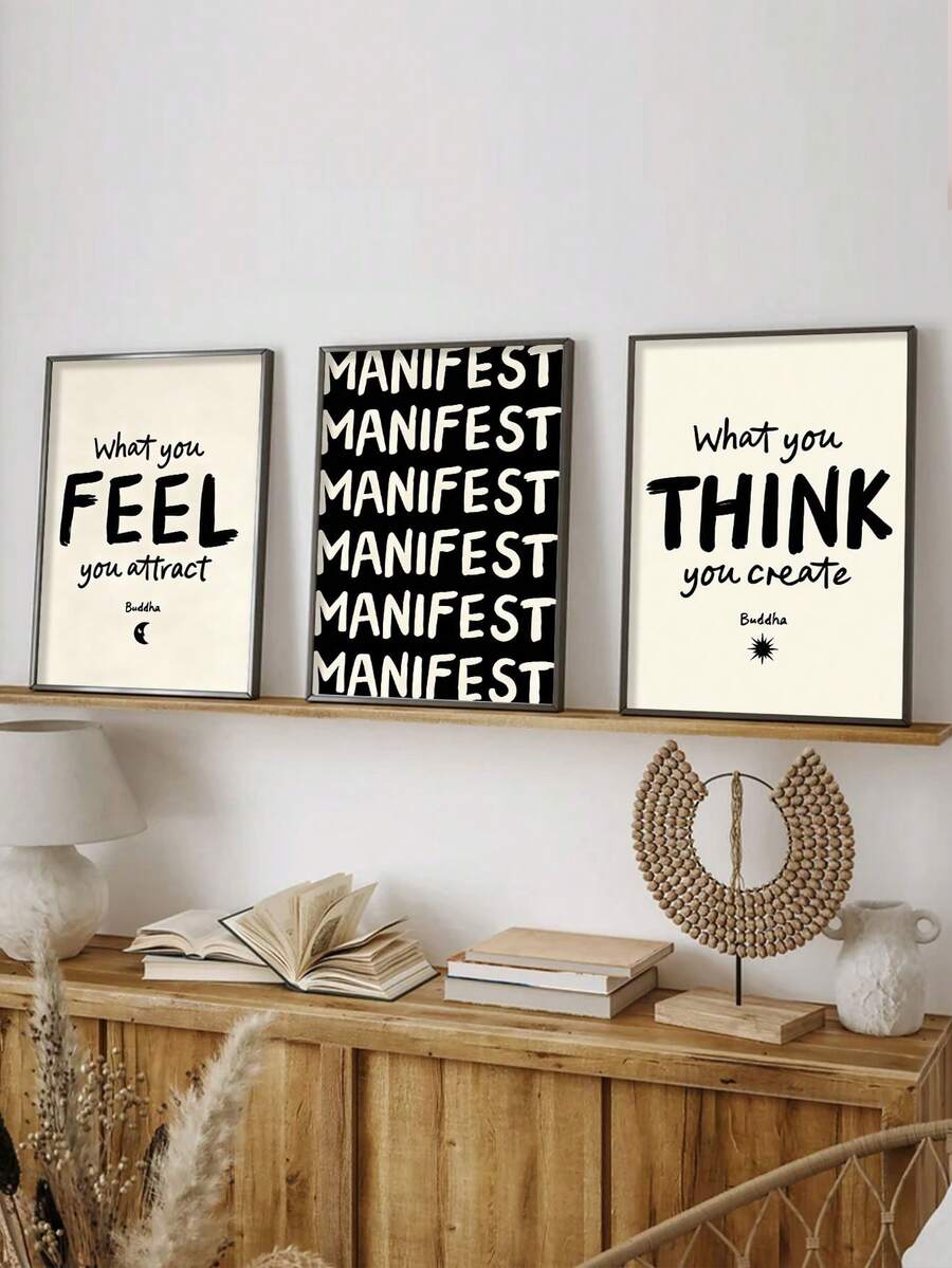 Framed manifestation quote canvas wall art set displayed on a wood shelf