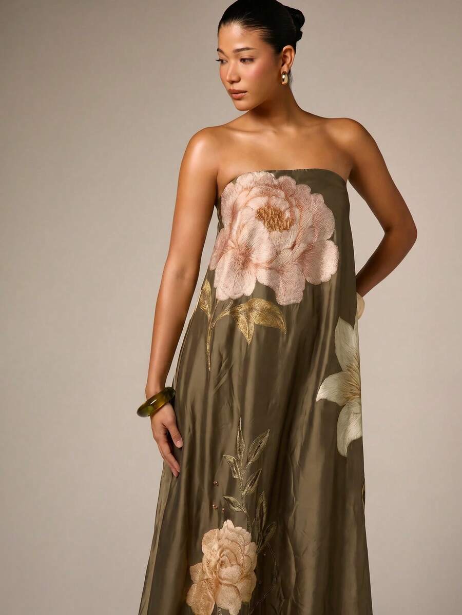 Close view of army green satin bodice and oversized pale rose embroidery
