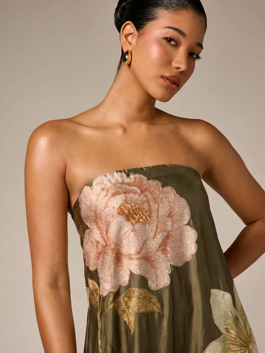 Detail of pale floral stitching and strapless neckline on army green satin gown