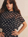 Full-length black polka-dot mini dress with loose overlay and fitted ruched skirt