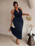 Front view of navy plus size halter maxi dress with gold collar and plunging drape