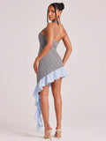 Back view of black and white gingham halter bodycon mini dress with open back and long ruffle tail