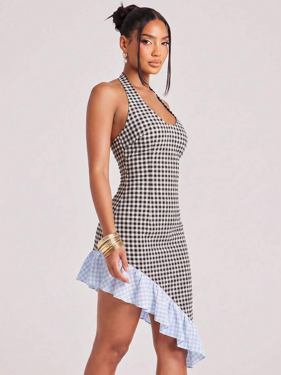 Three-quarter view of black and white gingham halter mini dress with fitted silhouette and high-low hem
