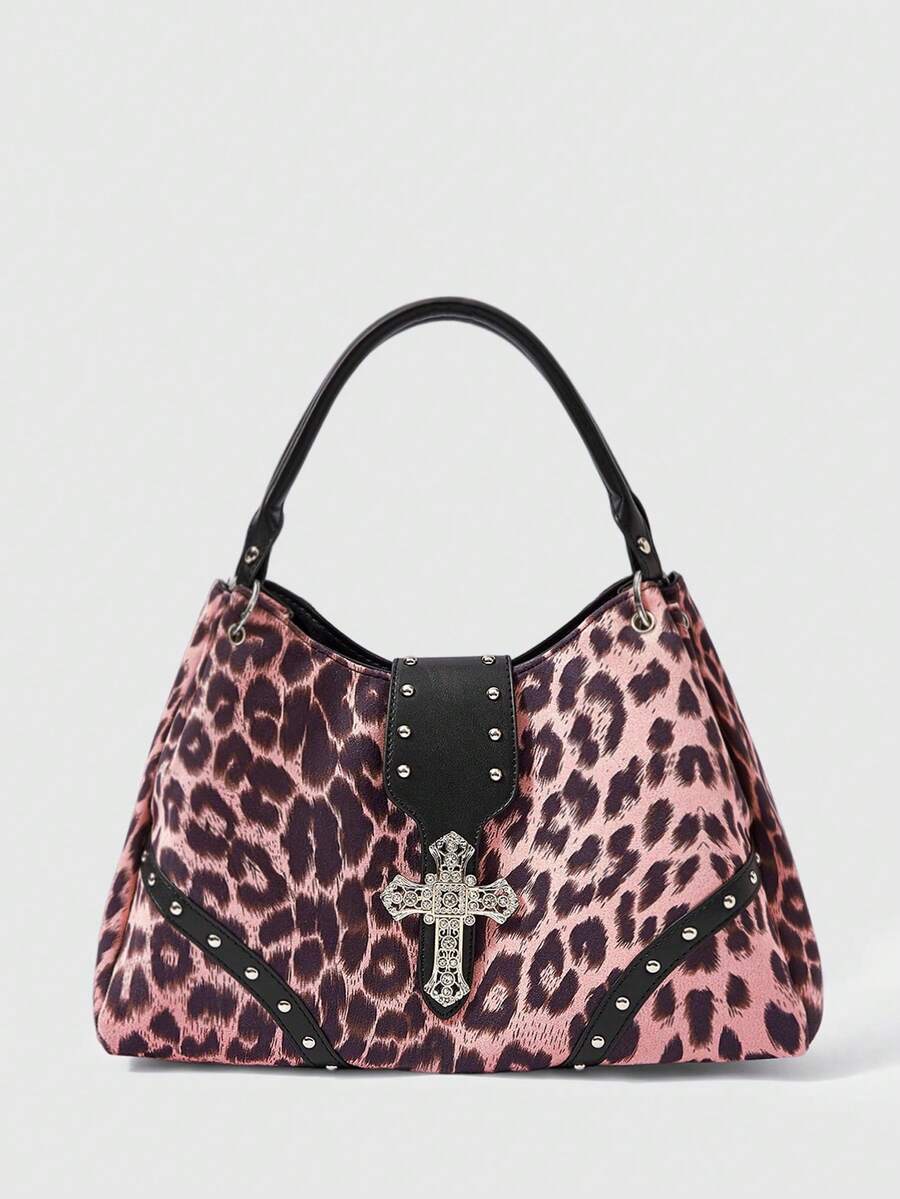 Full view of large burgundy patterned punk shoulder bag with silver cross hardware