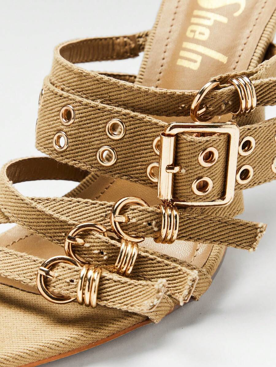 Khaki woven vamp close-up of pointed-toe buckle mule sandals with woven fabric upper, open toe, and high stiletto heel