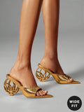 Side worn view of metallic gold open-toe mule sandals with wide vamp and hollow circular sculptural heel