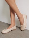 Cream smooth split-toe ballet flats with small bow