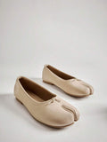 Pair of cream slip-on split-toe ballet flats