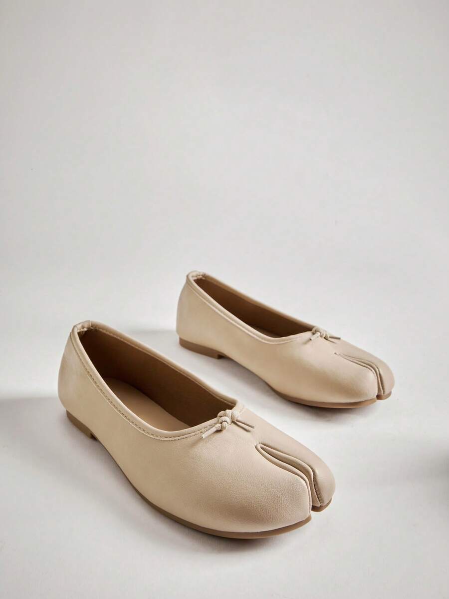 Pair of cream slip-on split-toe ballet flats