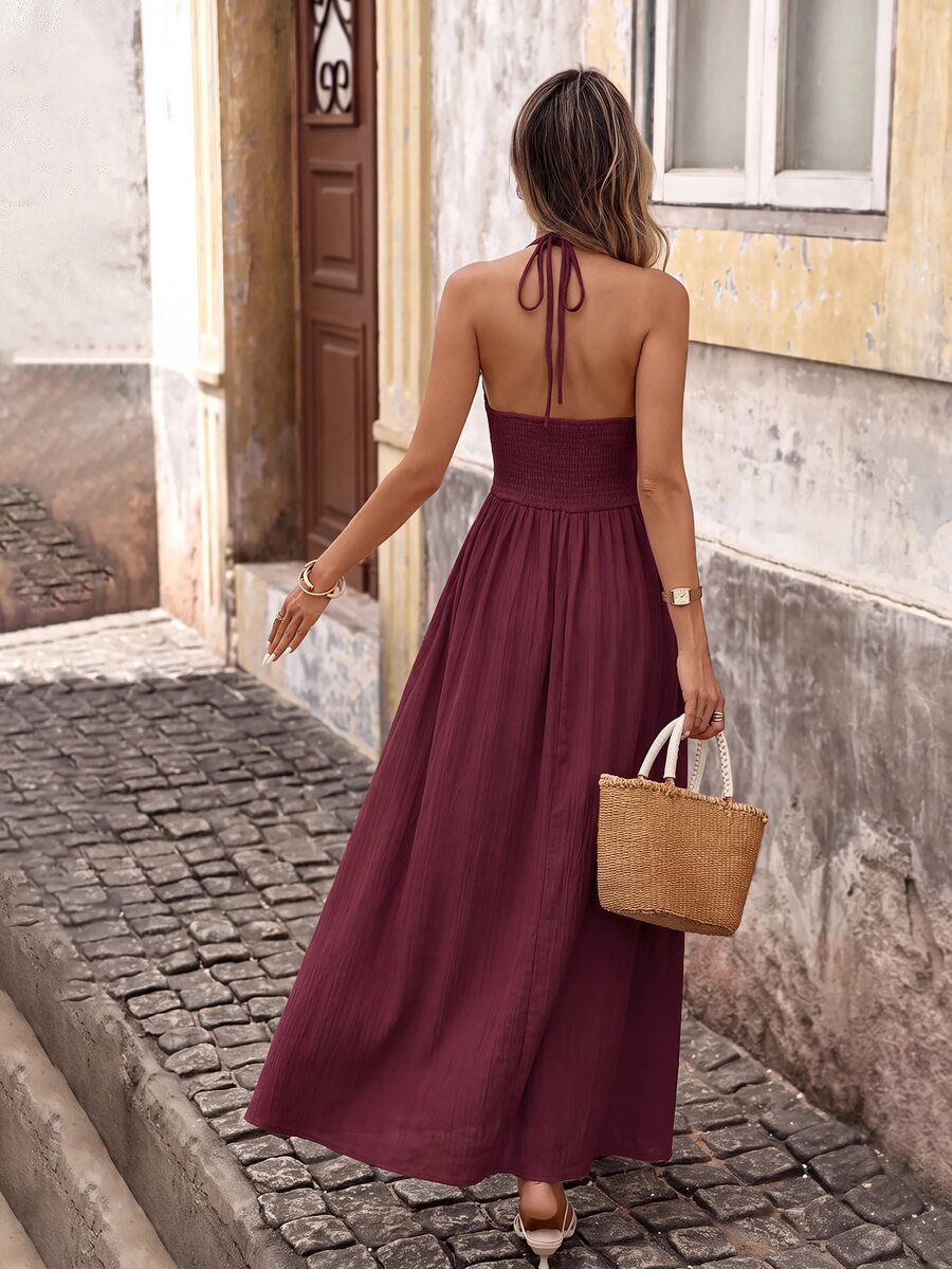 Back view of red plum boho halter maxi dress with open back and halter tie