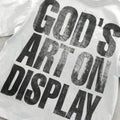 Close view of God’s Art On Display graphic on white T-shirt