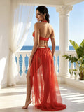 Back view of red open-back halter dance costume with long flowing skirt