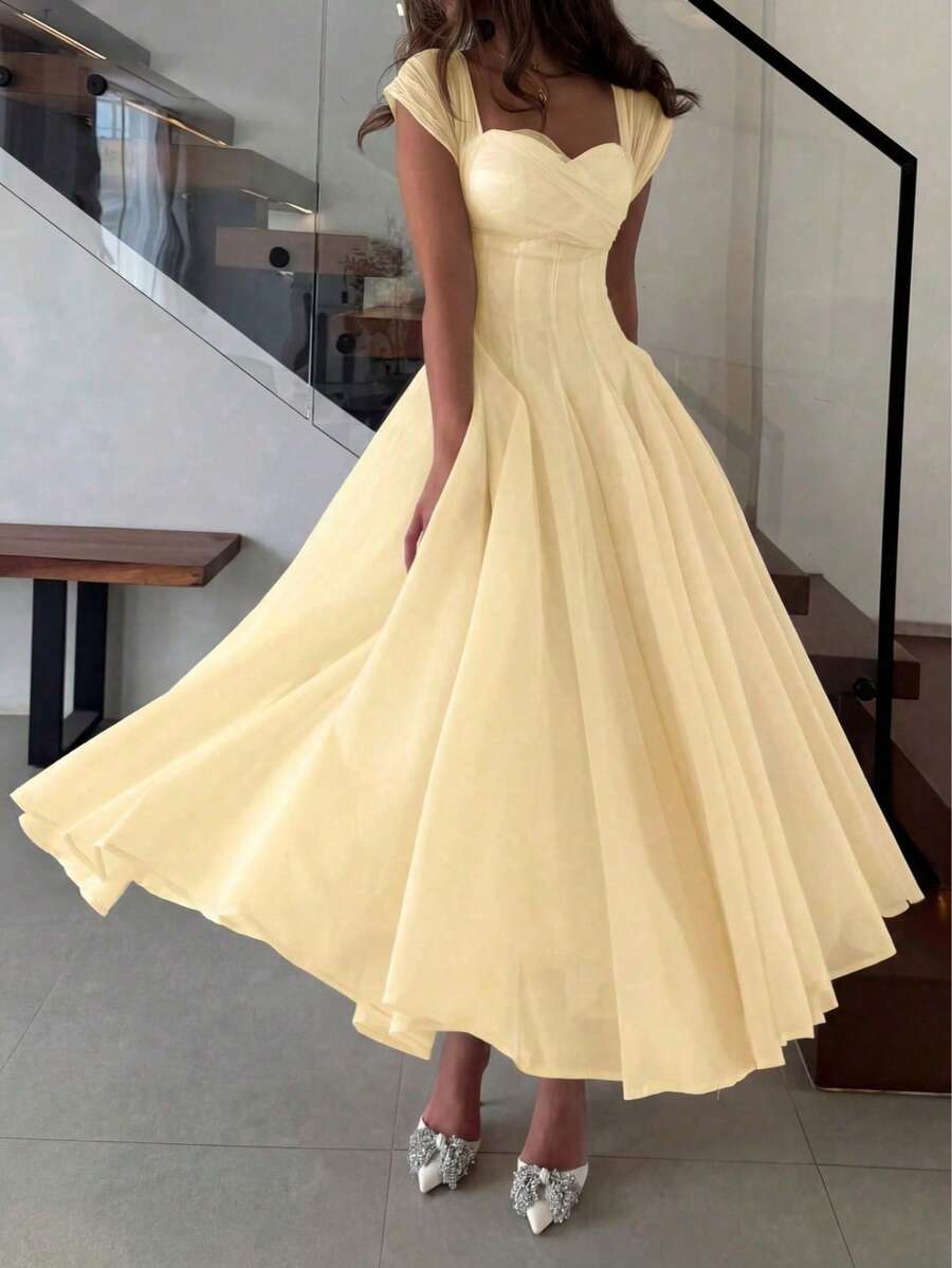 Front Full-Length View of pale yellow colorblock A-line midi dress with cap sleeves for wedding guest styling