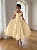 Front View of pale yellow colorblock A-line midi dress with cap sleeves for wedding guest styling