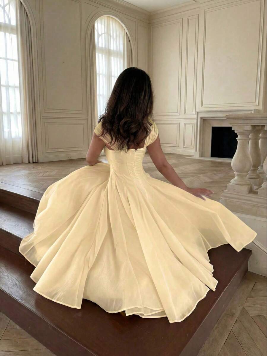 Back View of pale yellow colorblock A-line midi dress with cap sleeves for wedding guest styling