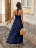 Back view of navy blue boho halter maxi dress with open back and halter tie