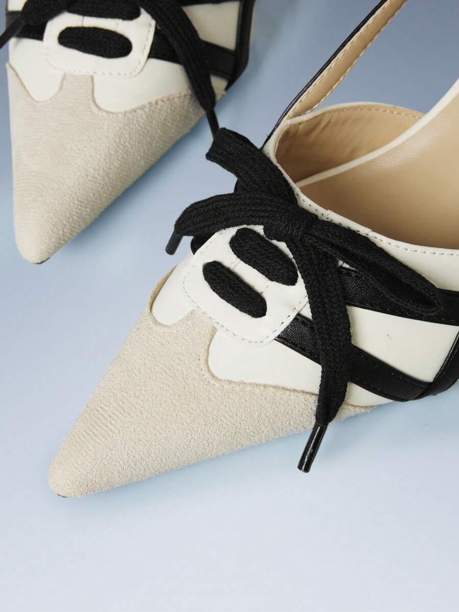 Yellow slingback pump with black trim, laces, and block heel