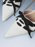 White textured toe slingback heel with black trim and laces