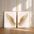 Framed gold angel wings wall art above a neutral console