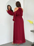 Back view of ruby red halter tie-back maxi dress with cold-shoulder sleeves
